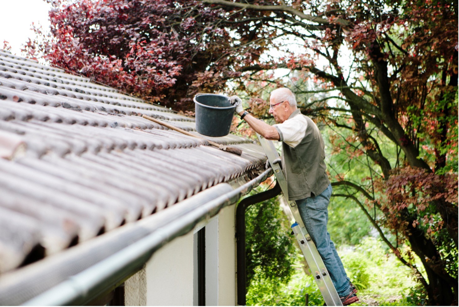 A man cleaning his gutters
