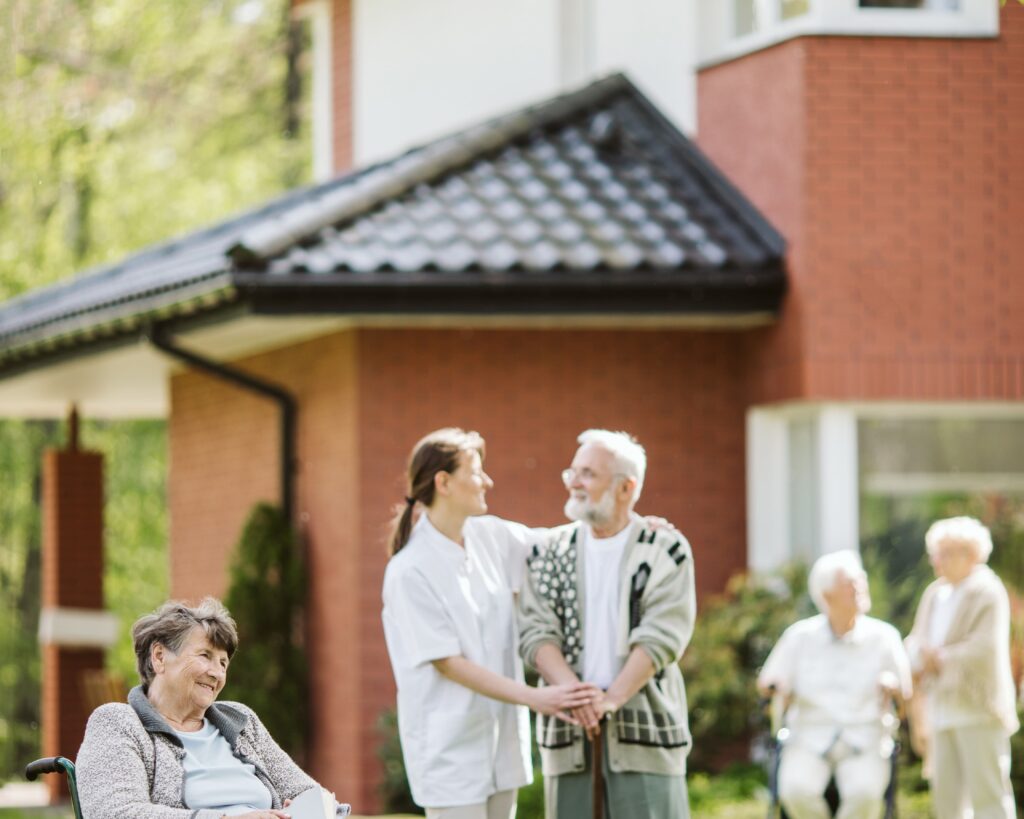 elderly people and caregiver in the garden