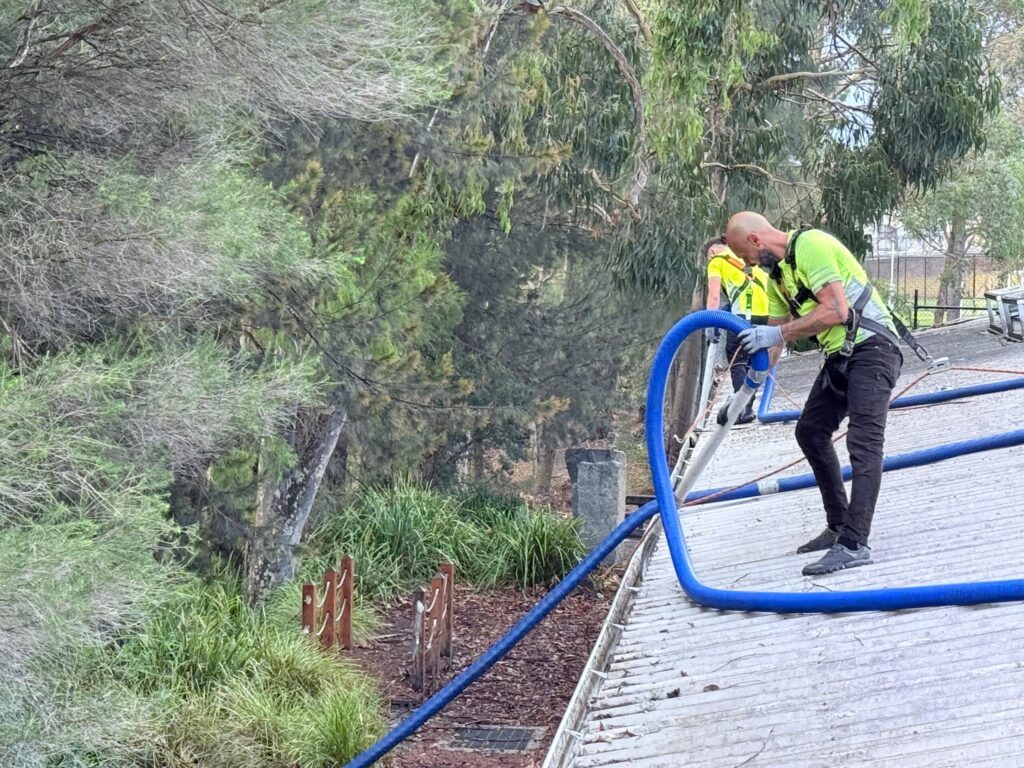 man cleaning roof gutters