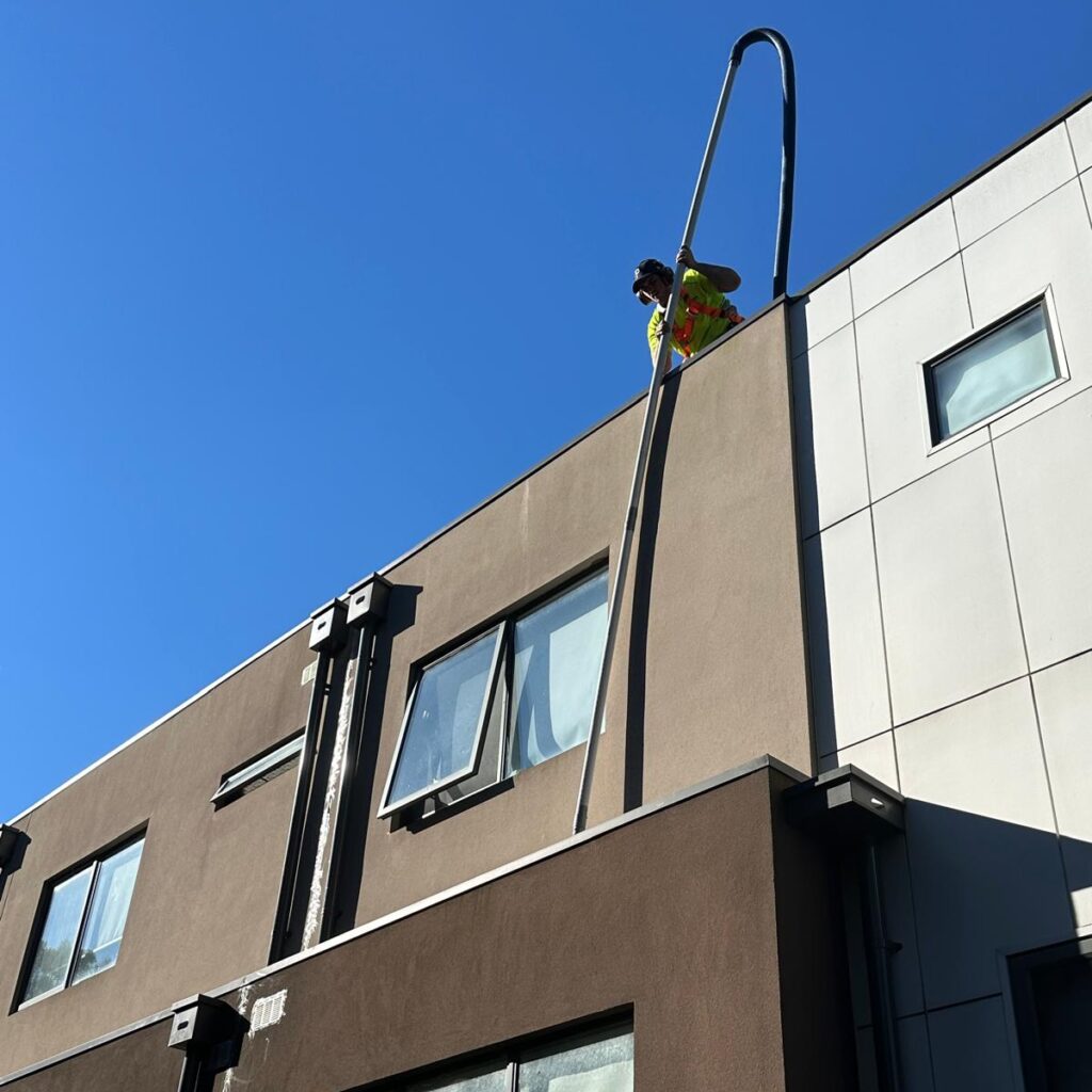portervac melbourne employee cleaning box gutter from roof