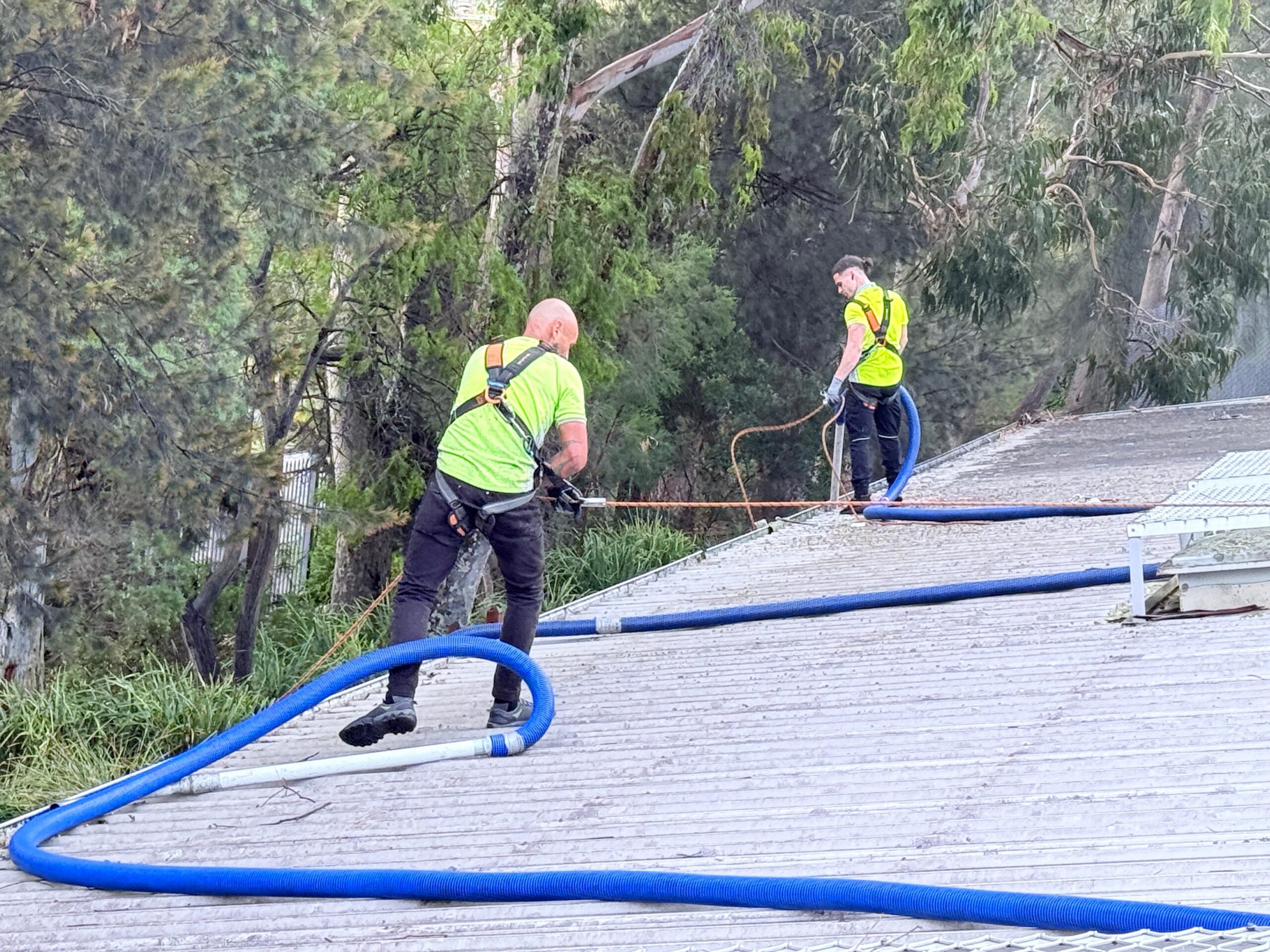 gutter cleaners using safety harnesses